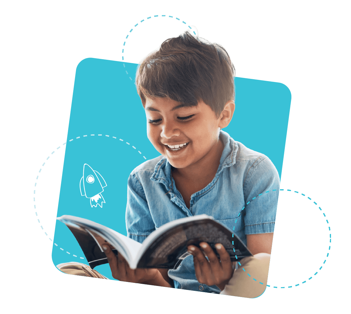 Young student smiles at book he's reading from Young student smiles at book he's reading from